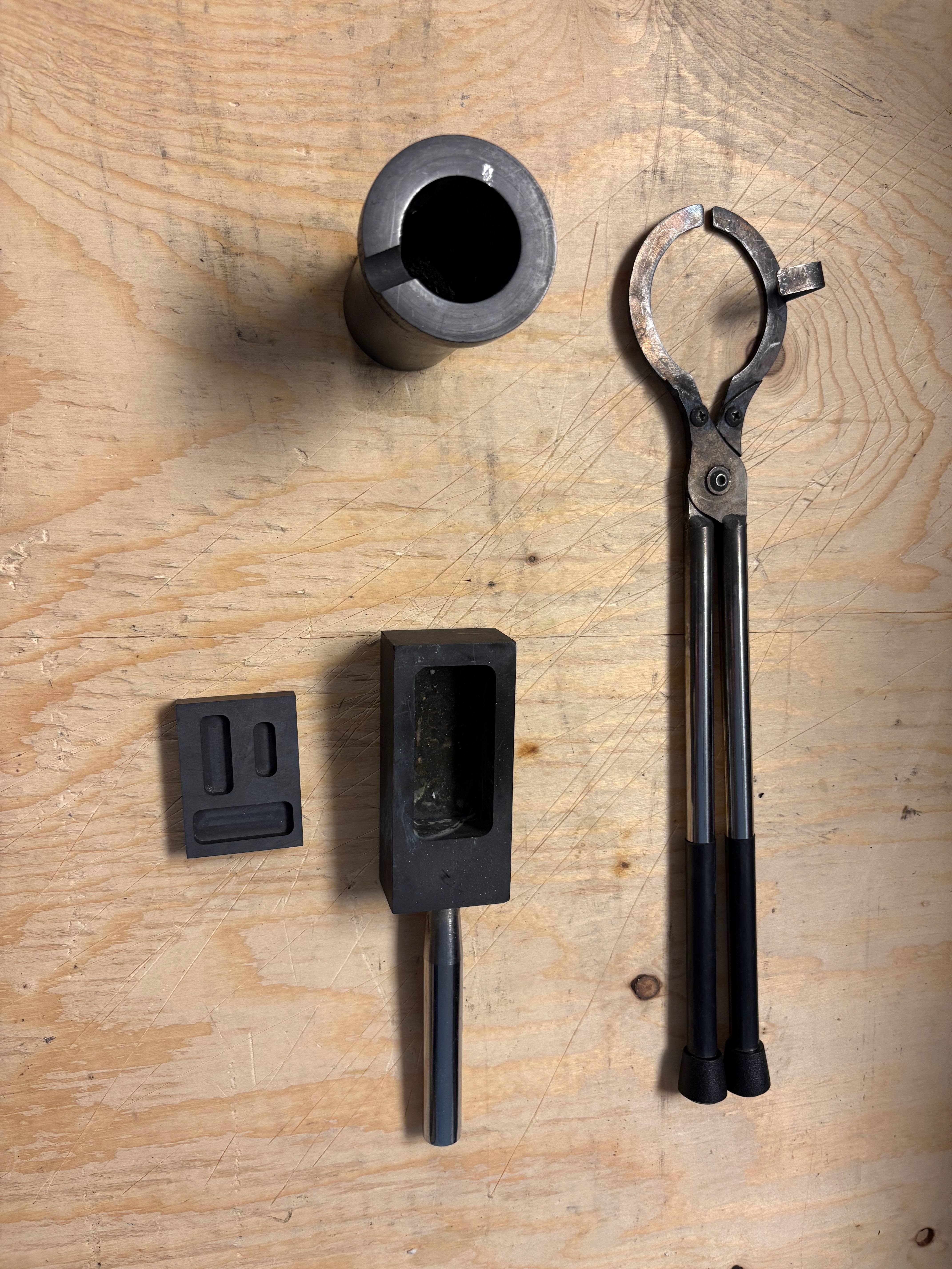 Tongs, crucible, and bar moulds.